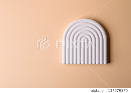 A beige background with a white podium for copy space items or cosmetics. A beige background 137979579