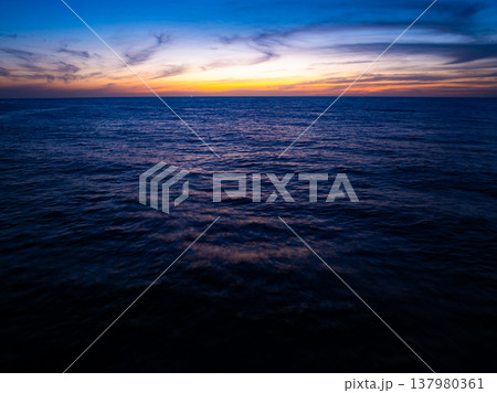 Beautiful Light Sunset or sunrise over sea,Aerial view scenery Sky with Amazing clouds and waves in sunset sky nature light cloud background 137980361