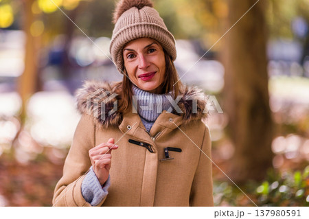 Woman experiencing eating disorder in autumn park Woman experiencing eating disorder in autumn park 137980591