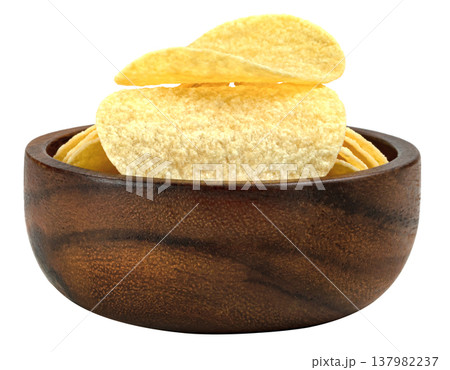Delicious crispy potato chips presented in a dark round wooden bowl. Savory snack food perfect for parties and appetizers. High quality close up studio food photography. Delicious crispy potato chips presented in a dark round wooden bowl. Savory snack food perfect for parties and appetizers. High quality close up studio food photography. 137982237
