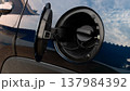 Close up shot of a car fuel filler neck with the gas cap removed. showing the circular opening for refueling. Designed for safe and efficient gasoline or diesel replenishment. 137984392