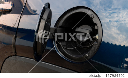 Close up shot of a car fuel filler neck with the gas cap removed. showing the circular opening for refueling. Designed for safe and efficient gasoline or diesel replenishment. Close up shot of a car fuel filler neck with the gas cap removed. showing the circular opening for refueling. Designed for safe and efficient gasoline or diesel replenishment. 137984392