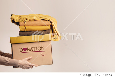 Donation Cloth, Renewable Concept.Hands lift up Used clothes box Donation Cloth, Renewable Concept.Hands lift up Used clothes box 137985673