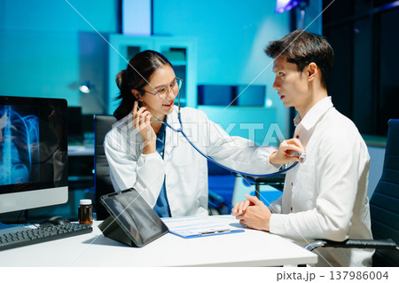 Professional doctor examining patient with stethoscope in modern clinic, healthcare consultation, medical checkup, diagnosis, trust, technology and wellness care. Professional doctor examining patient with stethoscope in modern clinic, healthcare consultation, medical checkup, diagnosis, trust, technology and wellness care. 137986004
