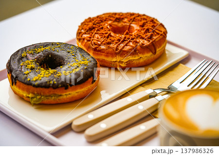 Cup of coffee decorated with a heart and dubai donuts Cup of coffee decorated with a heart and dubai donuts 137986326