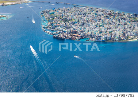 Radiant Male Maldives aerial landscape, turquoise ocean waters with boats, iconic cityscape view, tropical paradise, famous travel destination, scenic summer background Radiant Male Maldives aerial landscape, turquoise ocean waters with boats, iconic cityscape view, tropical paradise, famous travel destination, scenic summer background 137987782