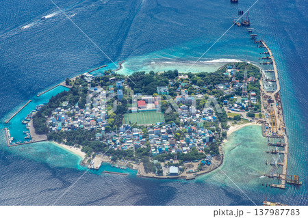 Majestic aerial view of Male Maldives capital city, turquoise ocean surrounding, boats and harbors, famous tropical destination, scenic travel landscape 137987783