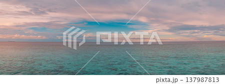 Majestic tropical ocean sunrise panorama radiant golden and pink sky, ethereal clouds reflected on calm turquoise water, serene inspirational nature landscape, dreamy idyllic summer banner wallpaper Majestic tropical ocean sunrise panorama radiant golden and pink sky, ethereal clouds reflected on calm turquoise water, serene inspirational nature landscape, dreamy idyllic summer banner wallpaper 137987813