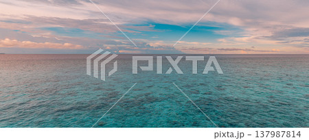 Radiant tropical ocean morning sunrise, colorful clouds over calm turquoise water, serene inspirational nature landscape, dreamy summer coastal banner background Radiant tropical ocean morning sunrise, colorful clouds over calm turquoise water, serene inspirational nature landscape, dreamy summer coastal banner background 137987814