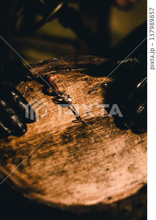 Antique key on the lid of a wooden barrel 137989857