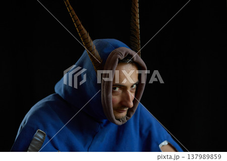 Portrait of a man in a medieval hood with pheasant robes. 137989859