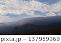 Misty waterfall in the mountains under a blue sky 137989969