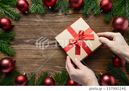 Hands holding Christmas gift box Hands holding Christmas gift box 137992248