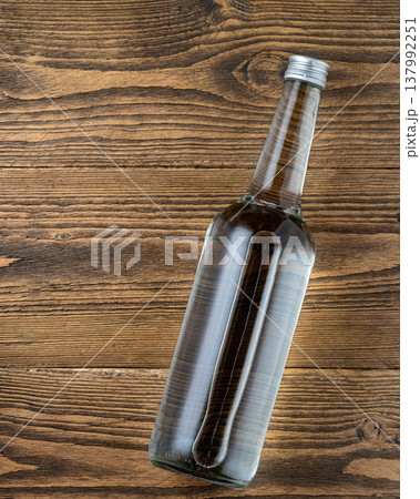 Vodka bottle on rustic wooden table 137992251