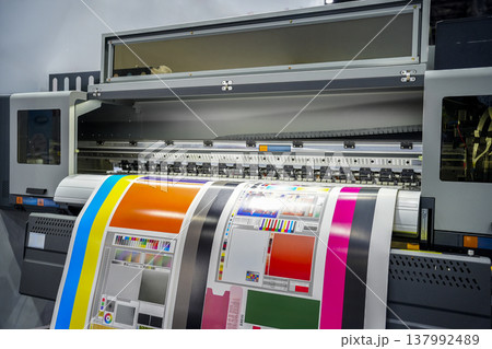 Large offset printing press or magazine running a long roll off paper in production line of industrial printer machine. Large offset printing press or magazine running a long roll off paper in production line of industrial printer machine. 137992489