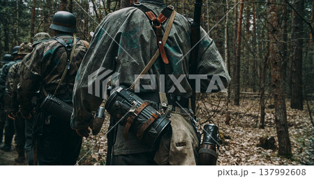 Close up of Wehrmacht soldier back with camouflage smock and combat gear Close up of Wehrmacht soldier back with camouflage smock and combat gear 137992608