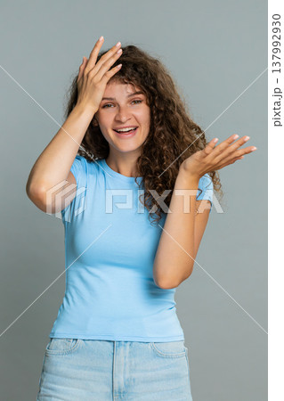 Woman making facepalm gesture laughing humorous reaction embarrassed funny silly mistake moment Woman making facepalm gesture laughing humorous reaction embarrassed funny silly mistake moment 137992930