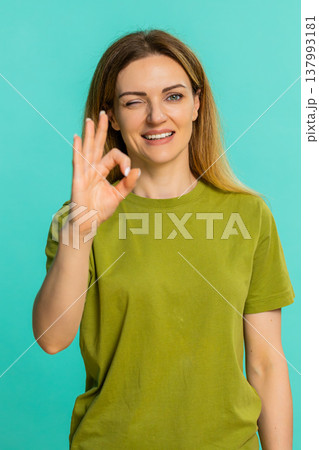 Woman showing OK gesture with fingers smiling expressing approval, agreement and positive feedback Woman showing OK gesture with fingers smiling expressing approval, agreement and positive feedback 137993181