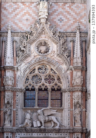 Detail of the Porta della Carta entrance to the Doge's Palace in Venice, Italy, depicting Doge Francesco Foscari kneeling before the Lion of St. Mark 137994393