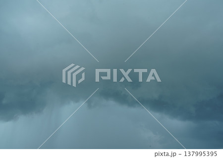 Dramatic Rain Clouds Against a Cloudy Sky 137995395
