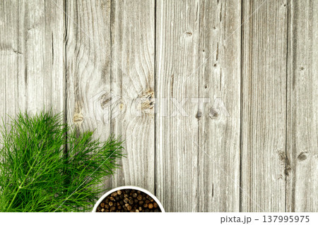 Healthy cooking concept with dill and peppercorns on wood table Healthy cooking concept with dill and peppercorns on wood table 137995975