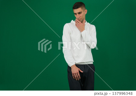 Young hoary man wearing casual green shirt standing isolated over white background. Relaxed with serious expression on face. Simple and natural looking at the camera. People and human expressions Young hoary man wearing casual green shirt standing isolated over white background. Relaxed with serious expression on face. Simple and natural looking at the camera. People and human expressions 137996348