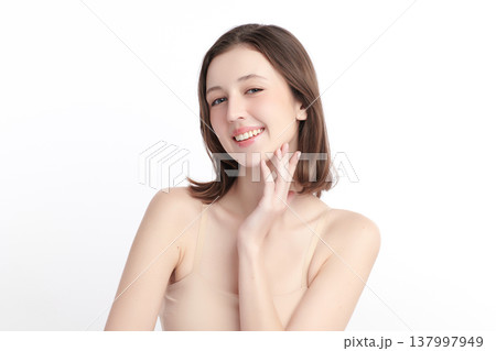 A beautiful young woman with clean, fresh skin against a white background. Skincare, facial treatment, cosmetology, beauty, and spa. An elegant portrait of an woman. A beautiful young woman with clean, fresh skin against a white background. Skincare, facial treatment, cosmetology, beauty, and spa. An elegant portrait of an woman. 137997949