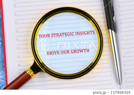 Magnifying glass on business planner reveals strategic insights for development, with a metallic pen Magnifying glass on business planner reveals strategic insights for development, with a metallic pen 137998305