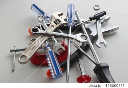 Heap Of Variety Colored Repairing Tools On White Surface Closeup View. Home Work And Repair Equipment Stock Photo  138000235