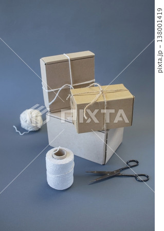 Cardboard boxes and packing twine, delivery concept. Stacking of postal cardboard boxes and packing twine. Cardboard boxes and packing twine, delivery concept. Stacking of postal cardboard boxes and packing twine. 138001419