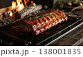 Realistic image of beef rib grilling on an open fireplace grate with flames and smoke 138001835