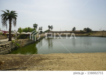 Sacred Lake at Karnak Temple with Palm Trees and Ancient Stone Ruins, Luxor Egypt Sacred Lake at Karnak Temple with Palm Trees and Ancient Stone Ruins, Luxor Egypt 138002731