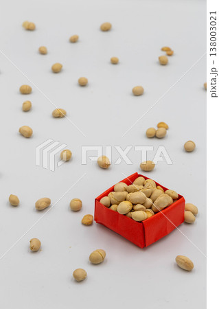 赤い折り紙の箱に入った大豆と散らばる豆 節分の豆まきイメージ 白背景 138003021