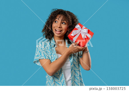 Grateful African Woman With Gift Box On Blue.Teenager Smiling,Present, Surprise Grateful African Woman With Gift Box On Blue.Teenager Smiling,Present, Surprise 138003725