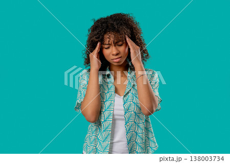 African Teen Girl Suffering Migraine Headache, Blue Studio. Hands On Head African Teen Girl Suffering Migraine Headache, Blue Studio. Hands On Head 138003734