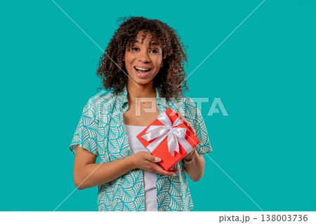 Grateful African Woman With Gift Box On Blue.Teenager Smiling,Present, Surprise Grateful African Woman With Gift Box On Blue.Teenager Smiling,Present, Surprise 138003736