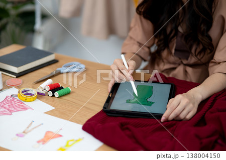 young woman designer drawing clothes design 138004150