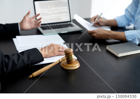 Lawyer explaining planned legal work to assistant to prepare documents Lawyer explaining planned legal work to assistant to prepare documents 138004330