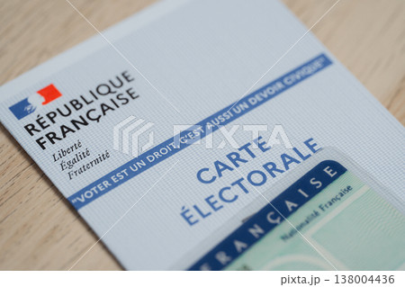 French voter card (carte electorale) alongside a partially visible national identity card and civic message, representing citizenship, democracy, election participation, voter identification. 138004436