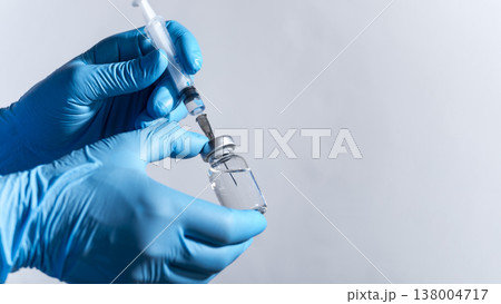 Medical Professional Preparing Syringe with Vial closep with copy space Medical Professional Preparing Syringe with Vial closep with copy space 138004717