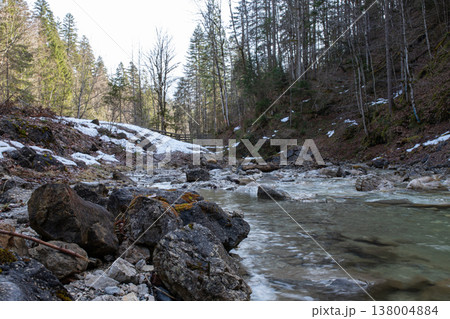 Rocky mountain stream with melting snow in late winter, Bavaria, Germany 138004884