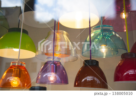 Colorful assortment of modern pendant lamps in a shop window Colorful assortment of modern pendant lamps in a shop window 138005010