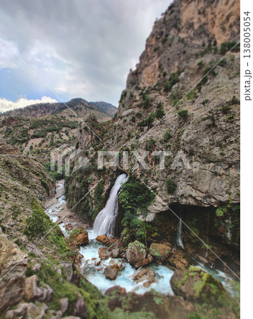 Kapuzbasi waterfall flowing from a mountain cliff into a river in Turkey Kapuzbasi waterfall flowing from a mountain cliff into a river in Turkey 138005054