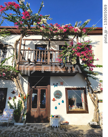 Traditional white house with a dark wooden balcony and bougainvillea in Kalkan Turkey 138005069