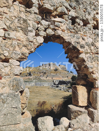 Ancient Lycian acropolis seen through a stone arch in Tlos Turkey 138005078