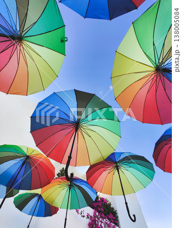 Low angle view of colorful rainbow umbrellas hanging against a blue sky in Bodrum, Turkey Low angle view of colorful rainbow umbrellas hanging against a blue sky in Bodrum, Turkey 138005084