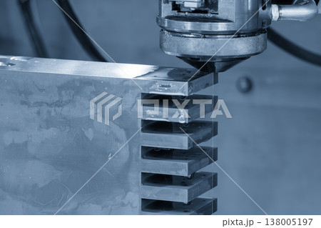Close-up of a high-precision Wire EDM cutting process on a metal workpiece in a smart factory environment. 138005197