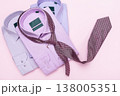 Three multicolored men's shirts and a tie on a pink background, a concept on the topic of matching a tie to a shirt, a top view 138005351