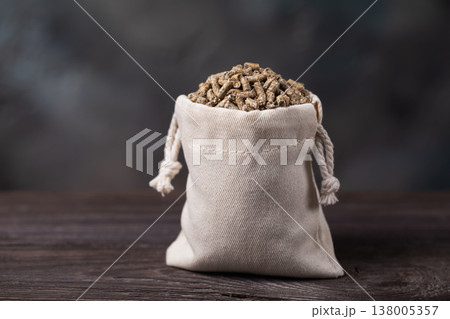 Combination feed in the form of bird pellets in a bag on a wooden table, authentic photograph, not AI-generated Combination feed in the form of bird pellets in a bag on a wooden table, authentic photograph, not AI-generated 138005357