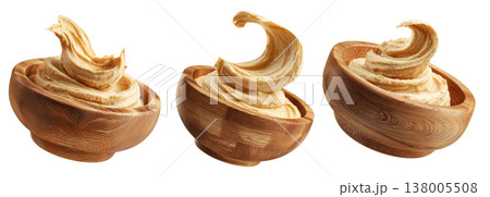 Swirled creamy hummus in wooden bowl, isolated on white transparent background. Concept of healthy vegan food and dip Swirled creamy hummus in wooden bowl, isolated on white transparent background. Concept of healthy vegan food and dip 138005508